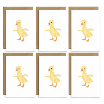 A set of 6 white greetings cards featuring an adorable illustration or a yellow duckling. No text. 6 cards are laid out on top of brown recycled envelopes. Easter greetings cards by Poppins and co.