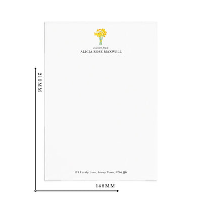 A single sheet of personalised letter writing paper by Poppins and co on a white background with dimensions displayed as 210mm by 148mm. The writing paper is white and has a small bunch of yellow daffodils illustrated at the top of the page. Italic script reads 'a letter from' with the name 'Alicia Rose Maxwell' typed in all caps font below it. At the bottom of the page is a typed address.