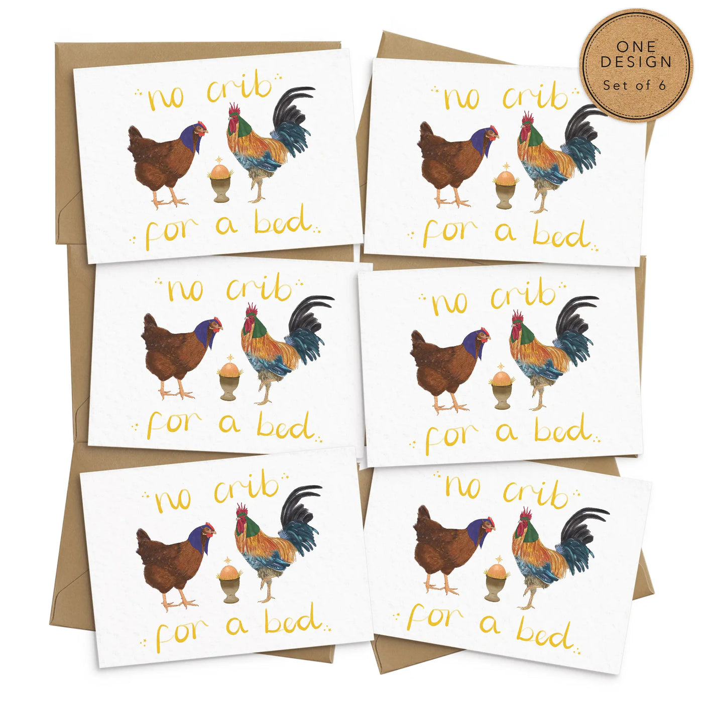 A unique set of 6 christmas cards lays on a white background with 6 brown envelopes. The card design depicts a whimsical illustration of nativity scene with Chicken as Mary, a cockerel as Joseph and an egg in an egg . Handcrafted yellow text reads 'no crib for a bed'.