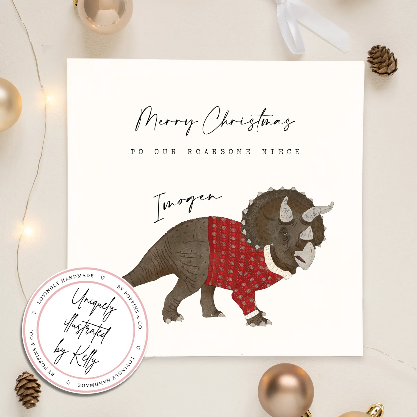 A personalised square greetings card featuring a unique illustration of triceratops in a christmas jumper and personalisable text reading 'Merry Christmas to our roar some niece Imogen'.