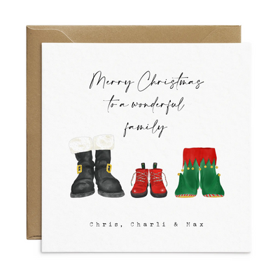 A square christmas card for a wonderful family - featuring unique watercolour illustrations of a pair of Santa boots and elf boots side beside, with baby christmas boots in-between. Personalised text reads 'Merry Christmas to a wonderful family - Chris, Charli and Max' 