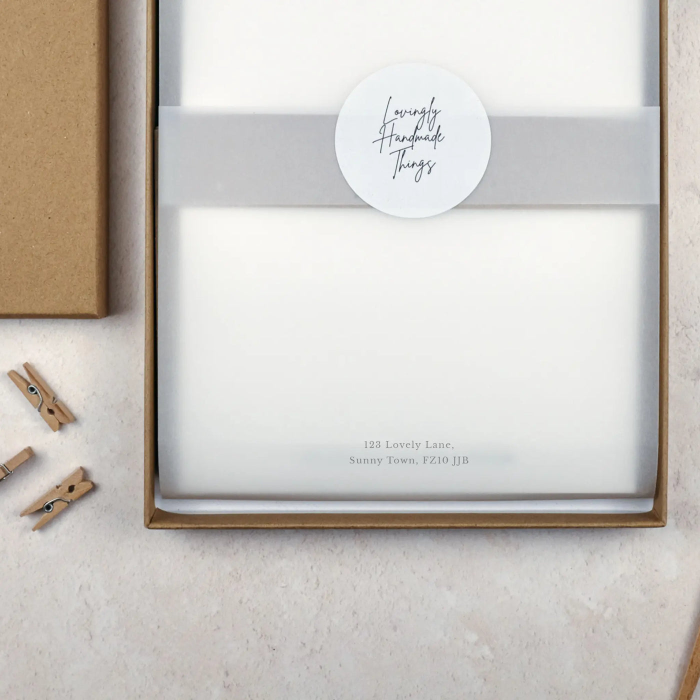 Packaged stationery paper set with a label on a light surface