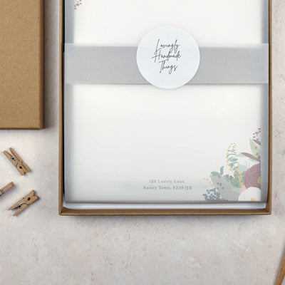 Packaged writing paper set in a brown kraft stationery gift box. The paper is wrapped with vellum and sealed with a white sticker which reads 'Lovingly Handmade Things'.